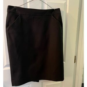 Misses slightly worn below the knee skirt